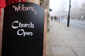 Sign saying Welcome Church Open indicating that the public christian church is open and welcoming believers during the covid 19 Royalty Free Stock Photo