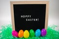 A Sign That Says Hoppy Easter With Easter Eggs