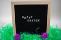 A Sign That Says Hoppy Easter With Easter Eggs