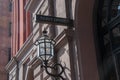 Sign that says Ticket Office on a stone building wall with an old gas lamp next to it. Royalty Free Stock Photo