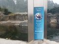 Sign on sea otter cage no tapping no climbing
