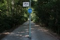 Sign separating a bicycle path from a pedestrian one, for safe movement, in a park.