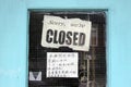 Sign on a shop door saying that they are closed in Chinatown, Vancouver, British Columbia, Canada