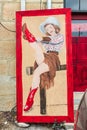 Sign showing a cowgirl in red cowboy boots outside a bar in Texas