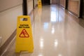 Sign showing warning of caution wet floor in hospital corridor Royalty Free Stock Photo