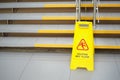 Sign showing warning of caution wet floor. Sign near the steps in an office or entertainment Mall. Cleaning of ceramic