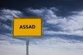Sign showing the word ASSAD, in the background is a stormy blue sky Royalty Free Stock Photo