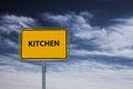 Sign showing the word KITCHEN, in the background is a stormy blue sky Royalty Free Stock Photo