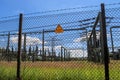 Sign showing the words high voltage in german language at the fence of a big substation distributing electric energy with lots Royalty Free Stock Photo