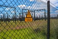 Sign showing the words high voltage in german language at the fence of a big substation distributing electric energy with lots Royalty Free Stock Photo