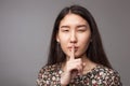 A sign of silence. The index finger at the mouth. Royalty Free Stock Photo