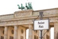 Sign of the square `Pariser Platz` at Brandenburg Gate, Berlin, Germany. The Brandenburg gate with Quadriga in the background Royalty Free Stock Photo