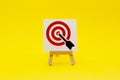 Sign stand with an arrow in the target on a yellow background. Hit exactly on center. Tactics of advertising targeting. advertise Royalty Free Stock Photo