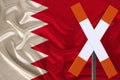 Sign, stop, attention against the background of the silk national flag of Bahrain, the concept of border and customs control,