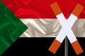 Sign, stop, attention on the background of the silk national flag of Sudan, the concept of border and customs control, violation