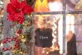 sign on the store with the inscription open. decorated with christmas decorations