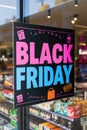 A sign in a store window advertising black friday sales, AI Royalty Free Stock Photo