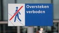 Sign at the streetcar station at Den Haag Centraal indication that crossing the tram rails is not allowed.