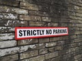 Sign Strictly No Parking red boarder on a brick wall Royalty Free Stock Photo