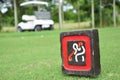 Sign at tee off with golf cart on golf course Royalty Free Stock Photo