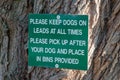 Sign telling you to keep dogs on lead and pick up there waste. Royalty Free Stock Photo