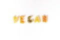 Sign, text vegan made of italian pasta on white background, veggie diet and eating concept