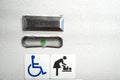 A sign in the toilet of an airplane, meaning that the toilet is equipped for disabled people. And it has a changing table Royalty Free Stock Photo