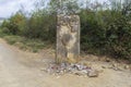 A sign totem waymark made in stone that guides the pilgrims along the Camino de Santiago, Spain.