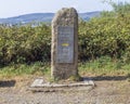 A sign totem waymark made in stone that guides the pilgrims along the Camino de Santiago, Spain.