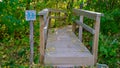 Sign of the tourist trail in the forest. Wooden sign shows tourists the directions of the trail.