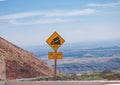 Sign of traffic alerts downhill slope.