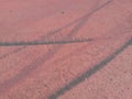 Rubber tire tracks on a bike path red colored