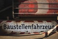 Sign under the rear light of a truck with the German words saying \