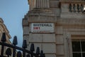 Sign of an underground Whitehall SW1 on the building