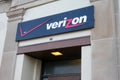 Sign for Verizon, a communications company, seen over a exterior building doorway