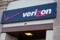 Sign for Verizon, a communications company, seen over a exterior building doorway