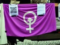 Sign for violent feminism on a purple cloth at the Women`s Day demonstration