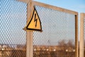 The sign warning about danger of electricity on a metal fence Royalty Free Stock Photo