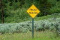 Sign warning drivers of frost heaves in the road Royalty Free Stock Photo