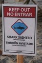 Sign warning about shark sighting along Pacific Coast