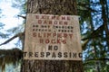 Sign warning of slippery rocks and danger, no trespassing