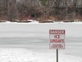 Unsafe ice sign on frozen lake Royalty Free Stock Photo