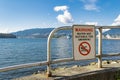 Sign `WARNING - WATER NOT SUITABLE FOR SWIMMING` in Stanley Park Vancouver. Royalty Free Stock Photo