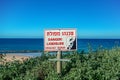 Sign that warns about the danger ahead of dubbed the Hebrew inscriptions