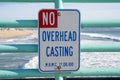 Sign warns visitors and fishermen of the no overhead casting rule on the pier. Taken in Manhattan Beach California