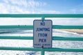 Sign warns visitors no jumping from the pier. Taken in Manhattan Beach, California