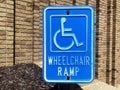 Sign wheelchair ramp. Blue square handicap sign with wheelchair ramp.