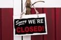 Sign of wood hanging on a door handle with sorry were closed Royalty Free Stock Photo