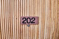 Sign on the wooden door. Room number in the hotel. Royalty Free Stock Photo