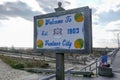 Sign with a wooden frame on a wooden post that says Welcome to Ventnor City that is located on the boardwalk near the beach